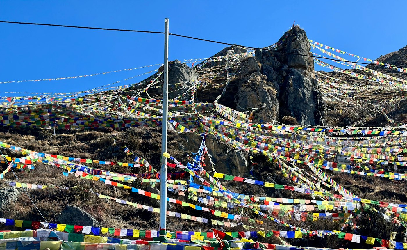Prayer flags strung across a Himalayan pass
